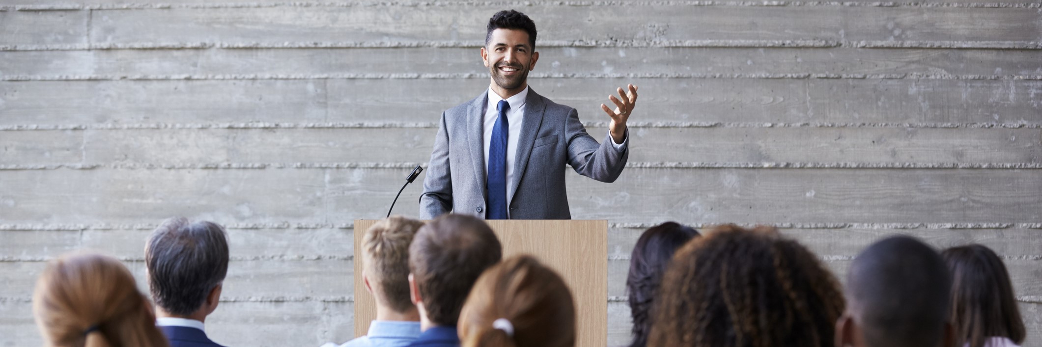 Man presenting from behind a podium